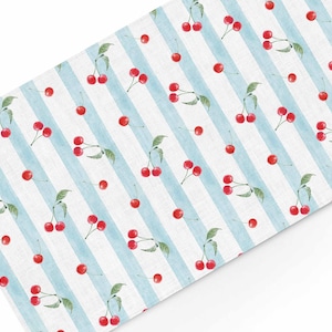 May include: A white and blue striped fabric with a repeating pattern of red cherries. The cherries have green stems and leaves.