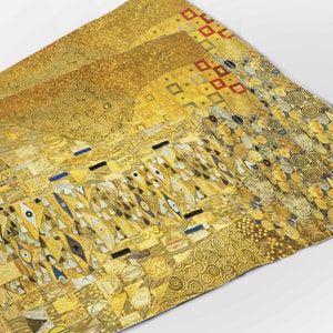 May include: A close-up of a gold-toned abstract painting with geometric shapes and swirling patterns. The painting is made up of various shades of gold, yellow, and red.