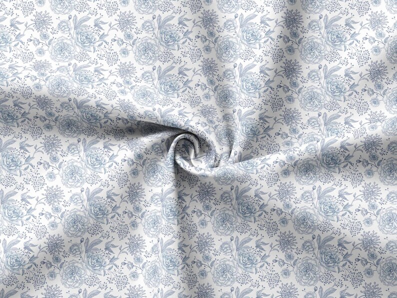 May include: White fabric with a blue floral pattern. The fabric is folded and twisted, showing the pattern in detail.