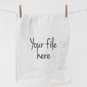 Pode incluir: Toalha de cozinha branca com o texto "Your file here" impresso em preto.