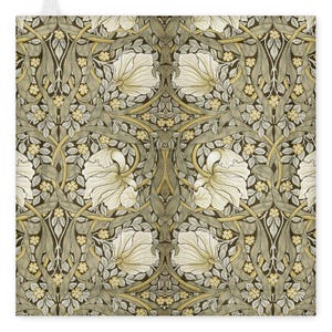 May include: A square textile with a repeating floral design in muted colours. Large, stylized white flowers are set amongst grey-green leaves and stems, against a dark backdrop. Small yellow blossoms add a touch of colour.