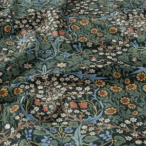 May include: A green fabric with a repeating floral pattern. The pattern features small white flowers, yellow flowers, blue flowers, and red flowers. The fabric has a textured surface.