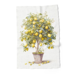 May include: A rectangular tea towel with a watercolour illustration of a lemon tree in a pot. The tree is full of yellow lemons and green leaves. The tea towel has a light beige background.
