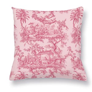 May include: A square cushion featuring a pink background and a red toile design. The pattern showcases scenes of people, trees, and buildings. The cushion has a soft, inviting appearance.