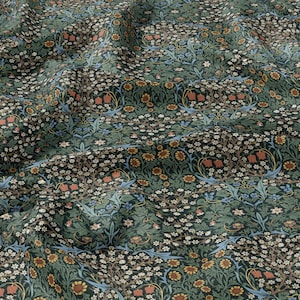 May include: A green fabric with a repeating floral pattern. The pattern features small white flowers, red and orange flowers, and blue birds.