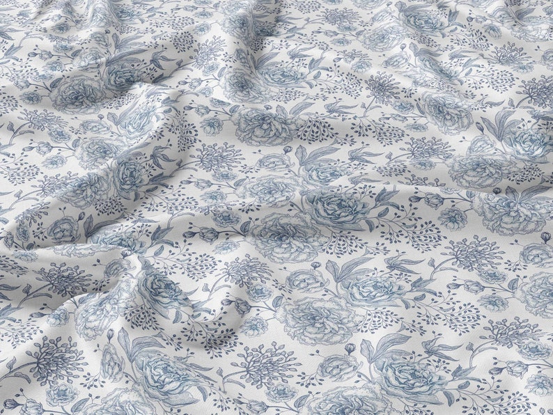 May include: White fabric with a blue floral pattern. The pattern features large peonies and smaller sprigs of flowers.