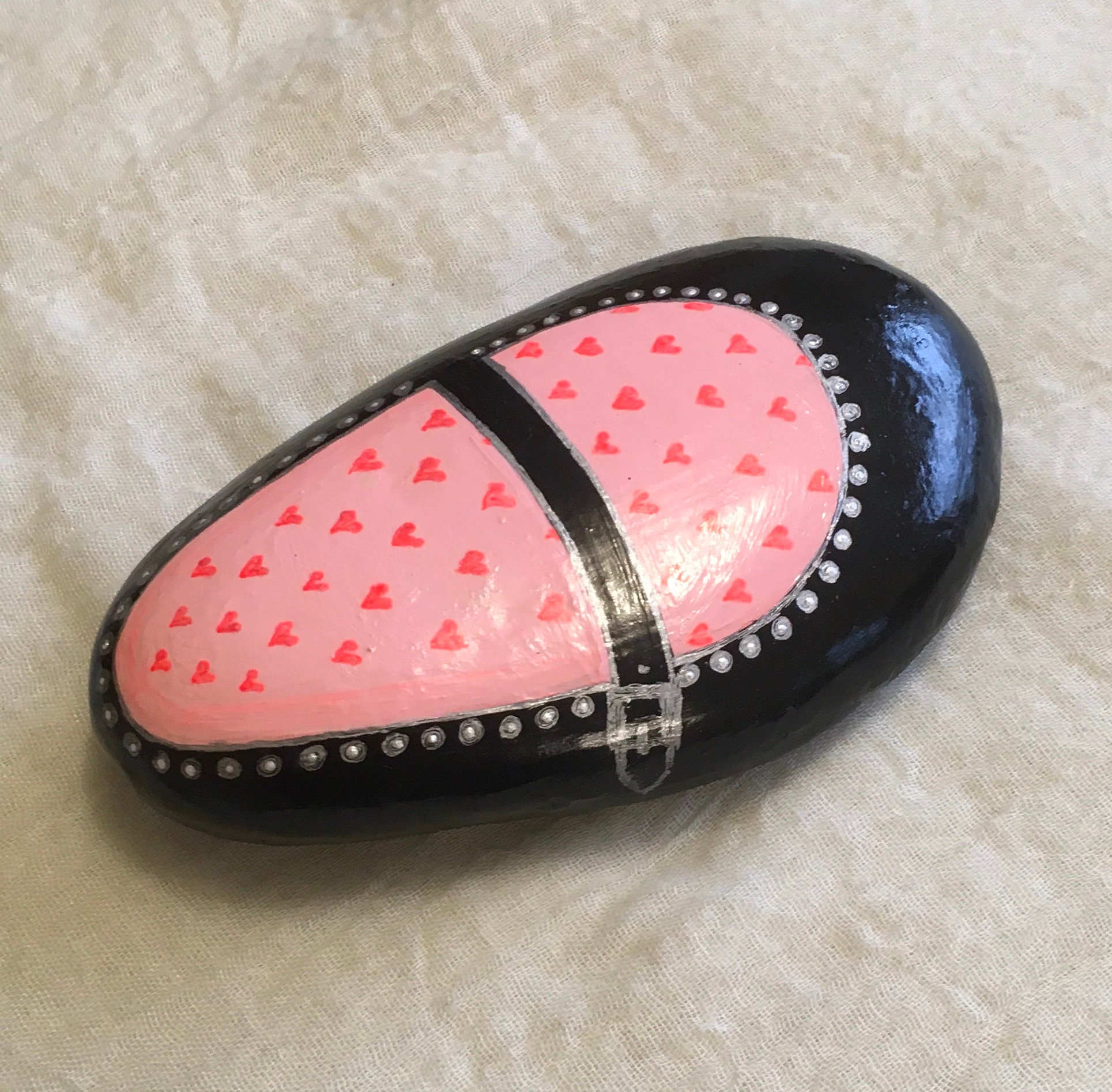 Red Sneaker Shoe Painted on A Small Stone is Painted With 