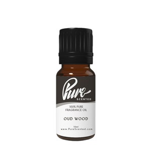 May include: A 10 ml bottle of 100% pure Oud Wood fragrance oil. The bottle is brown glass with a black cap and a white label with the text "Pure Scented" and "100% Pure Fragrance Oil Oud Wood 10ml www.PureScented.com".