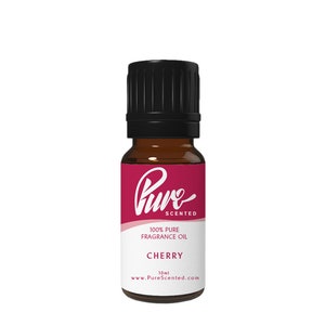 May include: A 10 ml bottle of Pure Scented Cherry fragrance oil. The bottle is brown glass with a black cap and a white label with the brand name and product information.