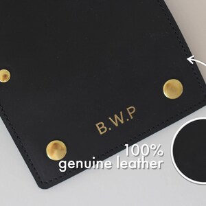 May include: Black leather wallet with gold rivets and the text "B.W.P. 100% genuine leather" embossed on the front.