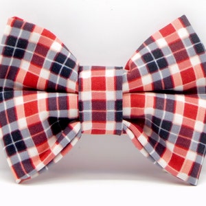 May include: A red, white and black plaid bow tie.