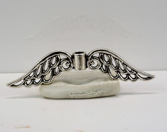 May include: Silver angel wing charm with a hole in the center for attaching to jewelry or other crafts.
