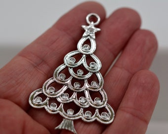 May include: Silver Christmas tree ornament with a star on top and rhinestones throughout the design.