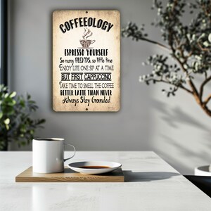 May include: A rectangular metal wall sign with a distressed beige finish featuring the black text COFFEEOLOGY, a coffee cup icon, and phrases including ESPRESSO YOURSELF, SO MANY BLENDS, SO LITTLE TIME, ENJOY LIFE ONE SIP AT A TIME, BUT FIRST CAPPUCCINO.