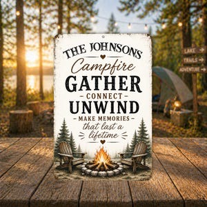 May include: A rectangular metal sign with the text "THE JOHNSONS Campfire GATHER - CONNECT - UNWIND - MAKE MEMORIES that last a lifetime". The sign features a campfire scene with two chairs and trees.