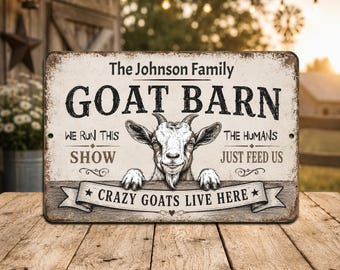 May include: A rectangular metal sign with a rustic design. The sign reads "GOAT BARN" with a goat illustration. Text includes "WE RUN THIS SHOW" and "THE HUMANS JUST FEED US." The bottom banner says "CRAZY GOATS LIVE HERE."