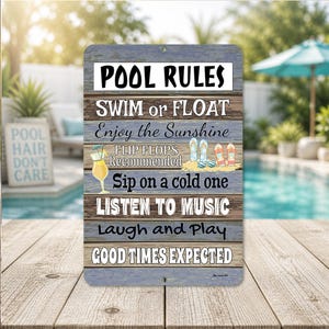 May include: A rectangular metal sign with a blue and brown wood-grain design. The sign reads "POOL RULES" followed by directives like "Swim or Float" and "Good Times Expected." A cocktail and flip-flops are illustrated on the sign.