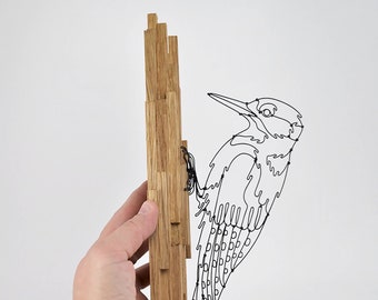 Woodpecker in black wire on oak wall lamp, animal sculpture in metal and wood, decorative bird
