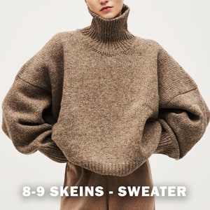 May include: A brown turtleneck sweater with a loose fit and long sleeves. The sweater is made of a chunky knit and has a relaxed, oversized look. The text "8-9 SKEINS - SWEATER" is printed at the bottom of the image.