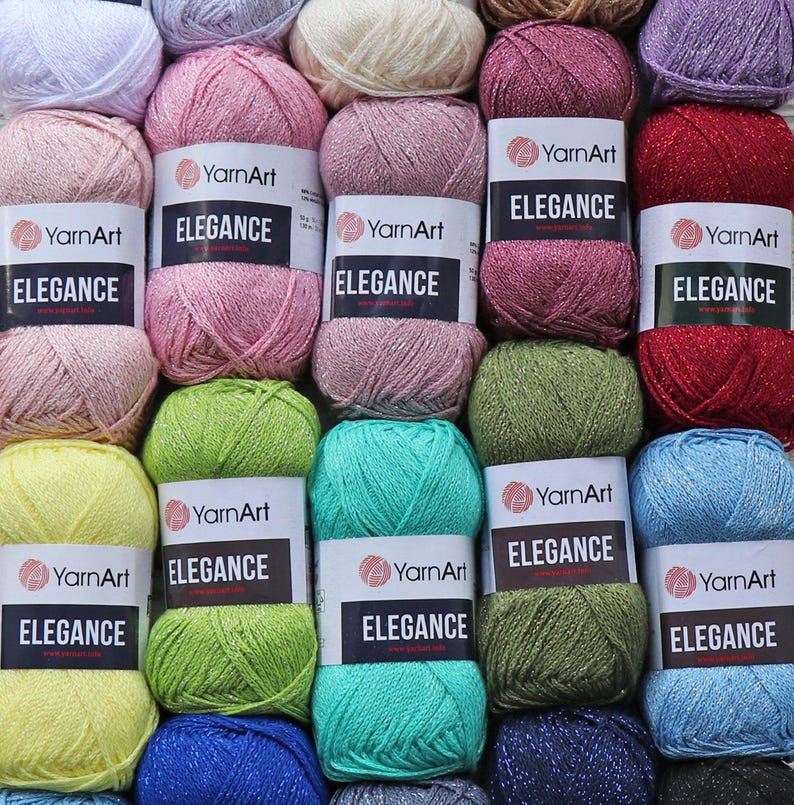 May include: Assortment of YarnArt Elegance yarn skeins in various colors, including pink, green, blue, and red. Each skein features a label with the brand name and the yarn's name, "Elegance".