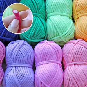 May include: Assortment of colourful cotton yarn balls in shades of blue, green, pink, and orange. The yarn is thick and textured, perfect for crocheting or knitting.