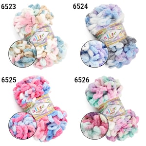May include: Four colorful skeins of Alize Puffy yarn. Each skein is a different color combination, including pink, blue, and green. The yarn is soft and fluffy, perfect for knitting or crocheting projects. Each skein has a label with the brand name and product number.