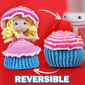May include: A reversible crocheted doll that can be flipped to reveal a cupcake. The doll has blonde hair, a pink dress, and a blue cupcake skirt. The cupcake side has pink and white stripes, a yellow cherry, and a blue cupcake base.