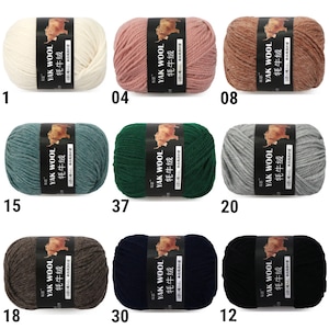 May include: Ten skeins of yarn in various colors, including white, pink, brown, green, blue, gray, and black. Each skein has a label that reads "YAK WOOL 牦牛绒" in black text on a white background.