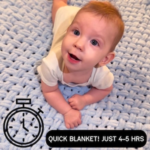 May include: A baby lies on a light blue, chunky knit blanket with a woven texture. The text "QUICK BLANKET! JUST 4-5 HRS" is displayed in a black box. A stopwatch graphic is in the corner.