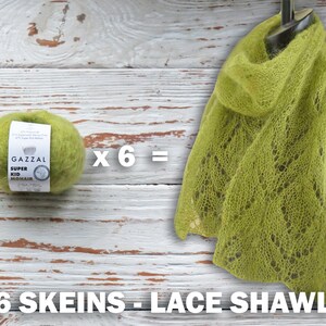 May include: A green lace shawl made with six skeins of Gazzal Super Kid Mohair yarn. The yarn label is visible in the image. The text on the label reads "Gazzal Super Kid Mohair".