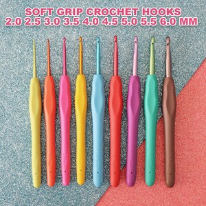 May include: Set of nine colourful crochet hooks with soft grips. The hooks are arranged in order of size, from 2.0 mm to 6.0 mm. The hooks are made of metal and have a plastic handle.