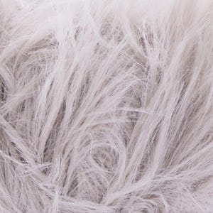May include: Close-up of a bundle of light gray yarn with a fluffy, textured appearance. The yarn fibers are long and flowing, creating a soft, cloud-like effect. Ideal for knitting or crocheting projects.