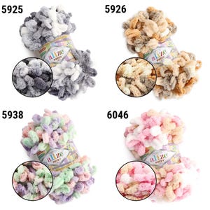 May include: Four colorful Alize Puffy yarn skeins. Each skein is a different color: gray, tan, pastel, and pink. Each skein has a circular close-up of the yarn's texture. The product number is visible on each skein.