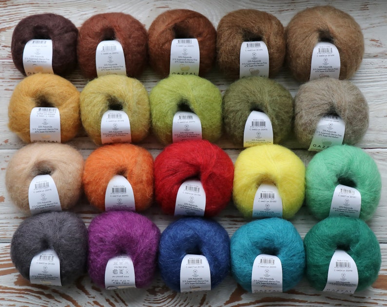 May include: Twenty skeins of yarn in various colors, including brown, orange, red, yellow, green, blue, purple, and gray. Each skein is wrapped in a circle and has a label with the brand name "GAZZAL" and other information.