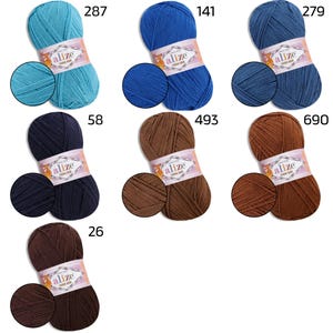 May include: A collection of Alize Cotton Gold yarn skeins in various colors, including teal, blue, navy, and brown. Each skein is labeled with a color number and a swatch of the yarn. Ideal for knitting and crochet projects.
