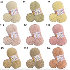 May include: A collection of Alize Cotton Gold yarn skeins in various colors, including beige, green, yellow, pink, and brown. Each skein has a matching swatch and a label with the brand name and color code.