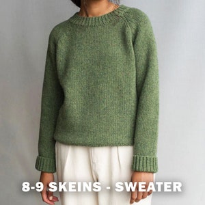 May include: A green knitted sweater with a round neckline and long sleeves. The sweater has a raglan sleeve construction and a ribbed cuff and hem. 8-9 skeins - Sweater