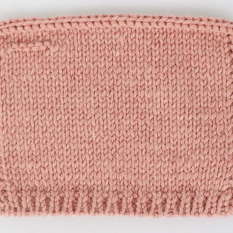 May include: A close-up of a knitted fabric in a dusty rose color. The fabric is knit in a simple stitch, creating a smooth and even texture.