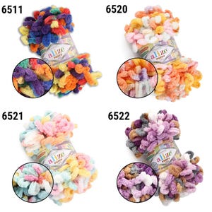May include: Four colorful skeins of Alize Puffy yarn. Each skein is a different color combination, including blue, orange, yellow, pink, and purple. The yarn is soft and textured, perfect for knitting or crocheting projects. The product code is visible on each skein.