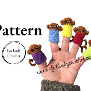 May include: Five finger puppets of brown monkeys wearing different coloured crocheted shirts. The puppets are on a hand, with the text "www.fatladycrochet.ca" visible below. The text "Pattern" is at the top of the image, and the text "Fat Lady Crochet" is in a circle below it.