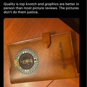 May include: A brown leather journal with a gold embossed Army National Guard logo and the text "1SG WASHBURN".