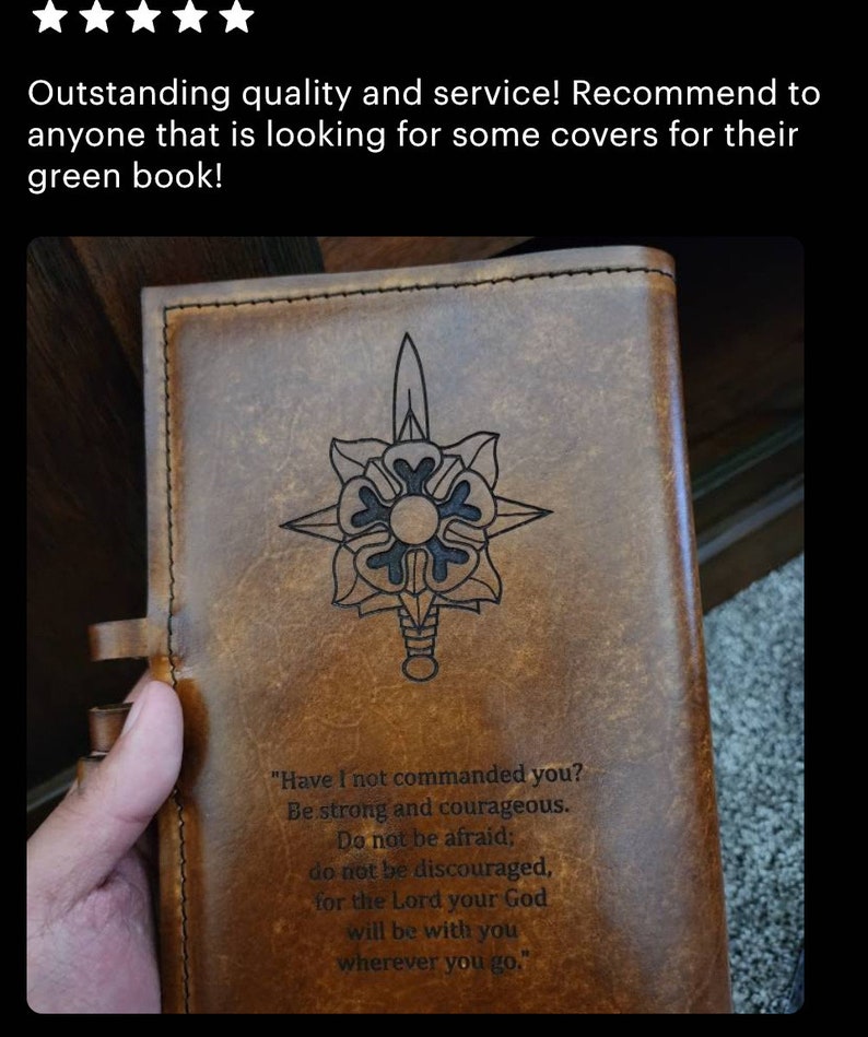May include: A brown leather journal with a decorative design of a sword and a flower. The journal has a quote on the front that reads "Have I not commanded you? Be strong and courageous. Do not be afraid; do not be discouraged, for the Lord your God will be with you wherever you go."