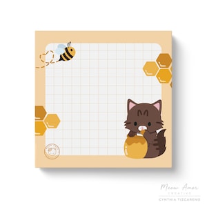 May include: A yellow and white notepad with a grid pattern. The notepad has a bee with black and yellow stripes and a cat with brown fur eating honey. The notepad has the text "Meow Amor Creative" and "Cynthia Tizcareno".