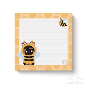 May include: A yellow and black bee and a cat dressed as a bee are on a notepad with a honeycomb pattern. The notepad has lined paper and a white border. The notepad has a small logo in the bottom right corner that says "Meow Amor Creative".