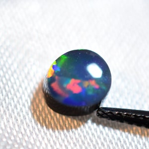 Australian Opal # 36 Doublet Brilliant 1.04 Carat Blue Red Green oval measuring 6.5 x 6 x 3.2 mm from Lightning Ridge Australia