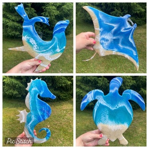 May include: Four resin ocean animal wall decor pieces. A blue and white seahorse, a blue and white manta ray, a blue and white sea turtle, and a blue and white seal.