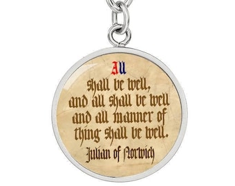 May include: A silver keychain with a round charm featuring a quote by Julian of Norwich: "All shall be well, and all shall be well and all manner of thing shall be well." The quote is written in a medieval script on a parchment background.