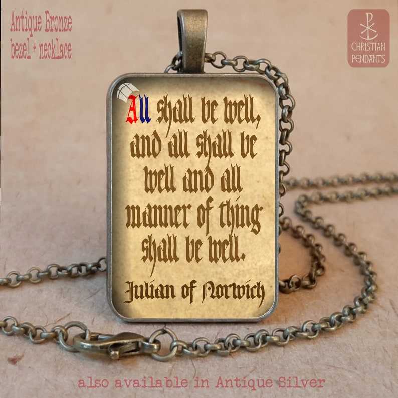May include: Antique bronze necklace with a rectangular pendant. The pendant features a quote from Julian of Norwich: "All shall be well, and all shall be well and all manner of thing shall be well." The text is in a vintage style font.