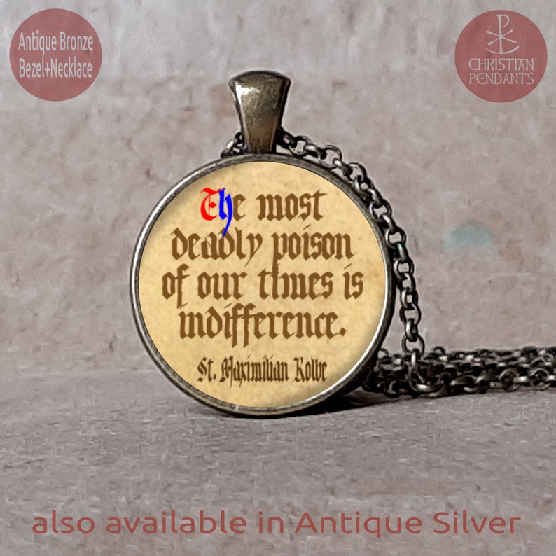May include: An antique bronze bezel necklace with a round pendant. The pendant features a quote: "The most deadly poison of our times is indifference." The text is in a vintage font. The necklace is also available in antique silver.