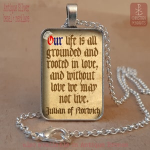 May include: Antique silver pendant necklace featuring a rectangular pendant with a quote from Julian of Norwich: "Our life is all grounded and rooted in love, and without love we may not live." The text is in a vintage style font.